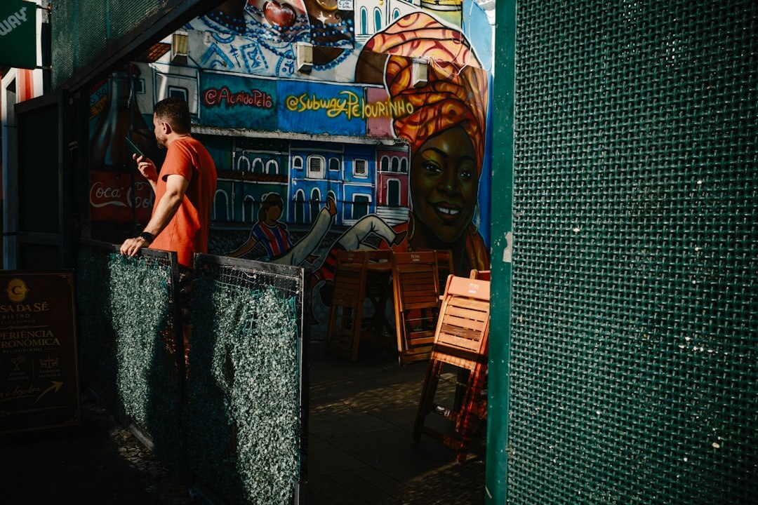 Two Brazilian friends talking at an outdoor cafe table