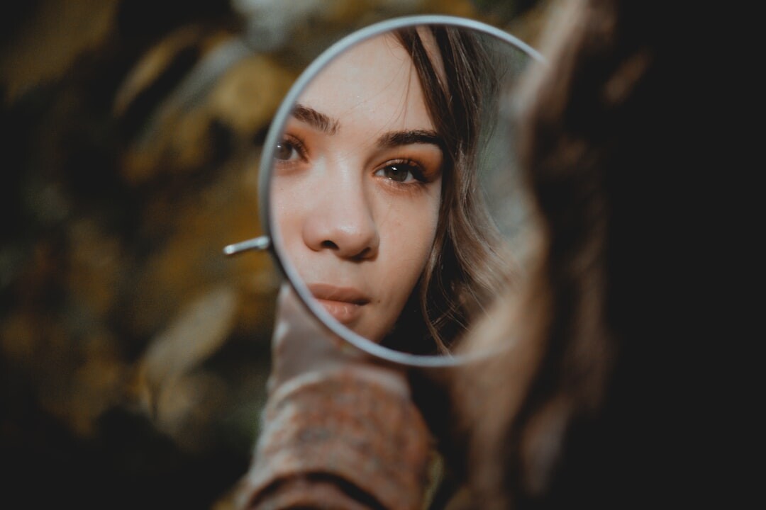 person looking at mirror reflection