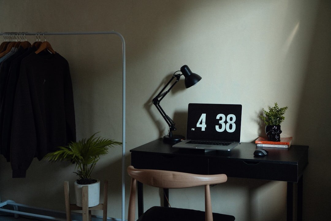 Small home office workspace with laptop and notebook