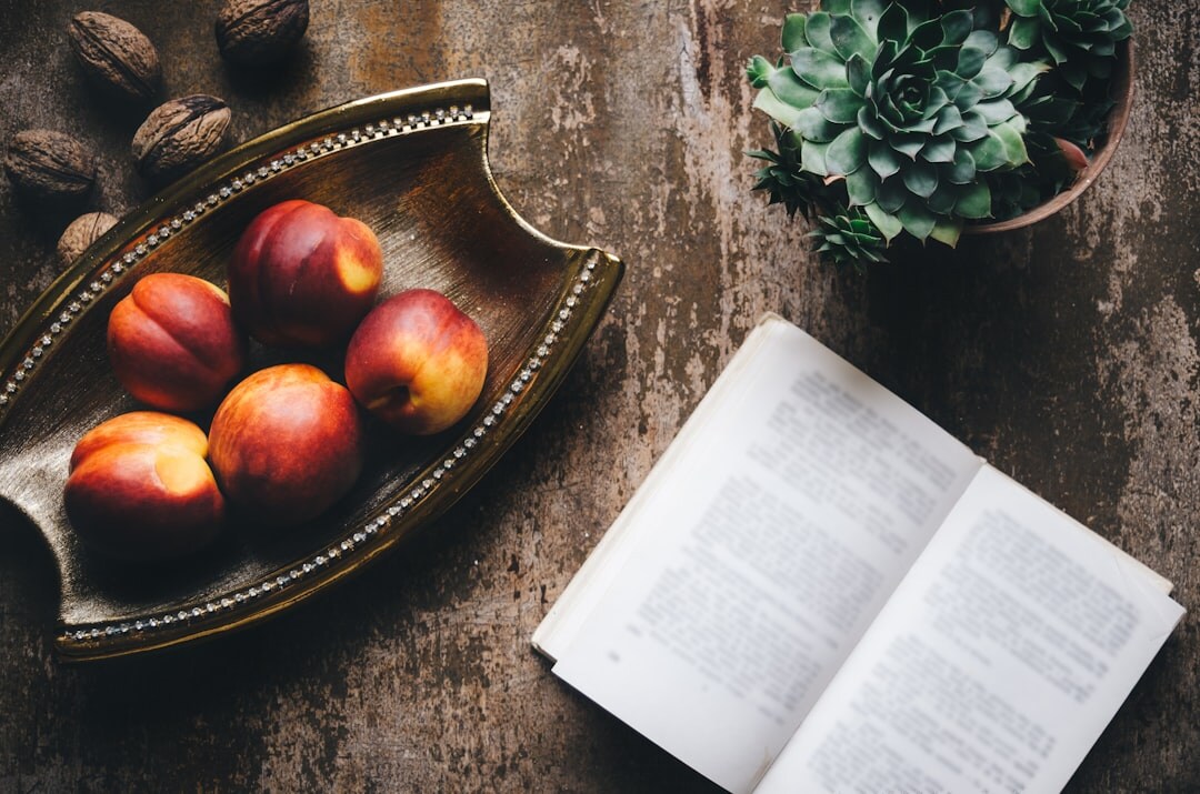Open book and cup of tea on a rustic table