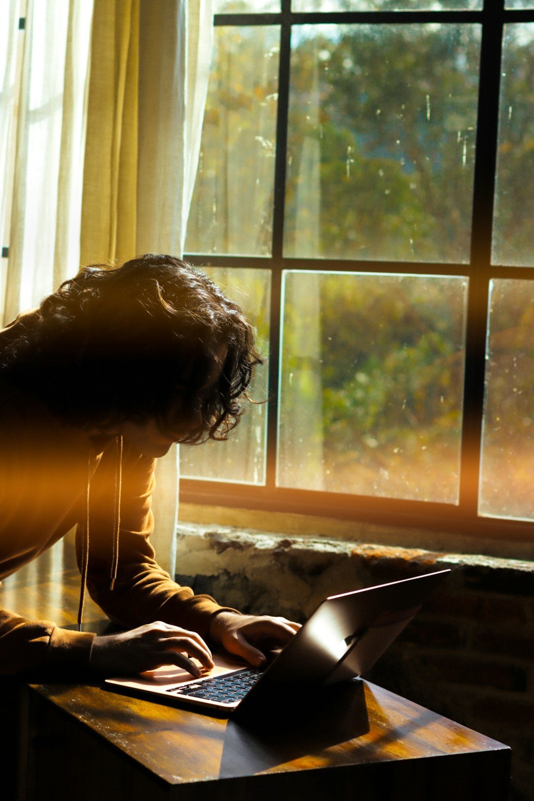 Brazilian woman writing in a journal at a sunlit desk